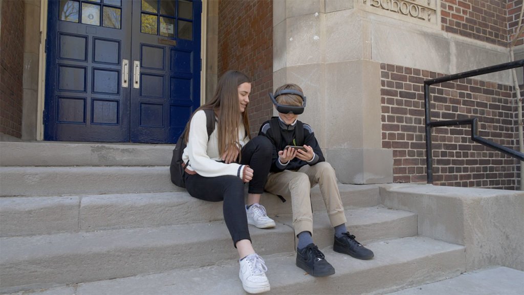 Kids on school steps using eSight Kids on school steps using eSight